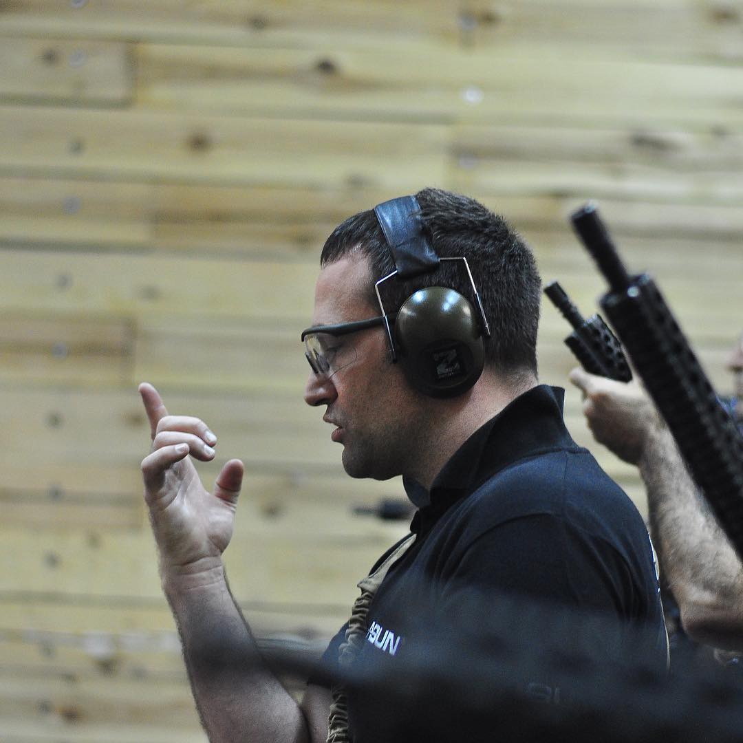 Instructor giving a hand signal on the indoor range