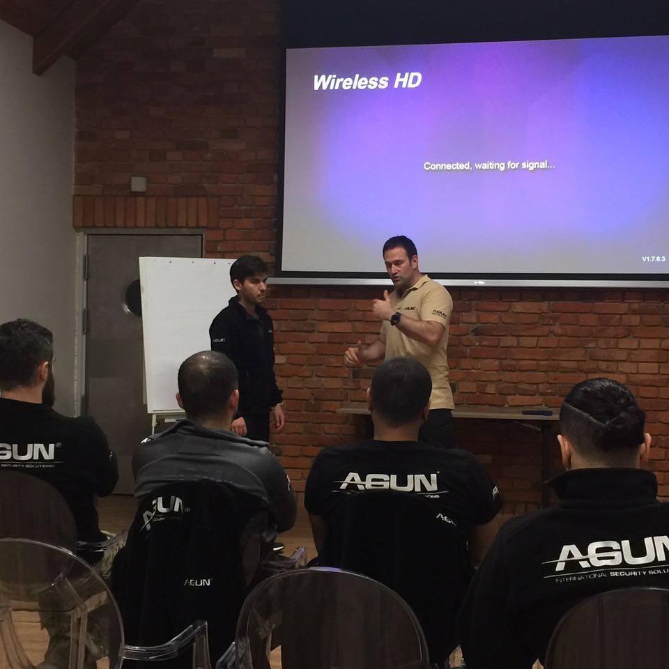 Instructor addressing a seated group in a seminar room