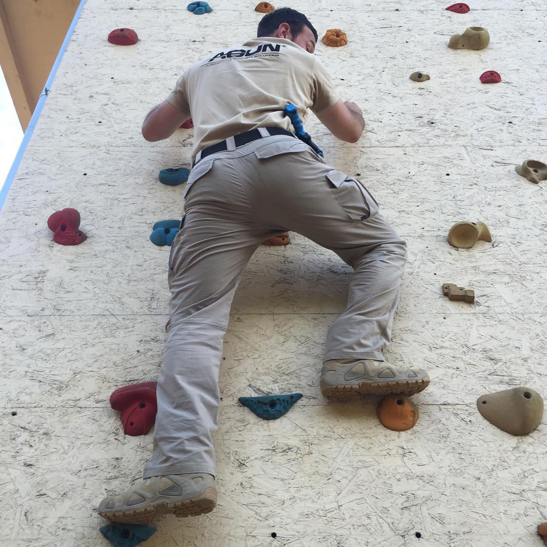 Trainee climbing the obstacle-course wall
