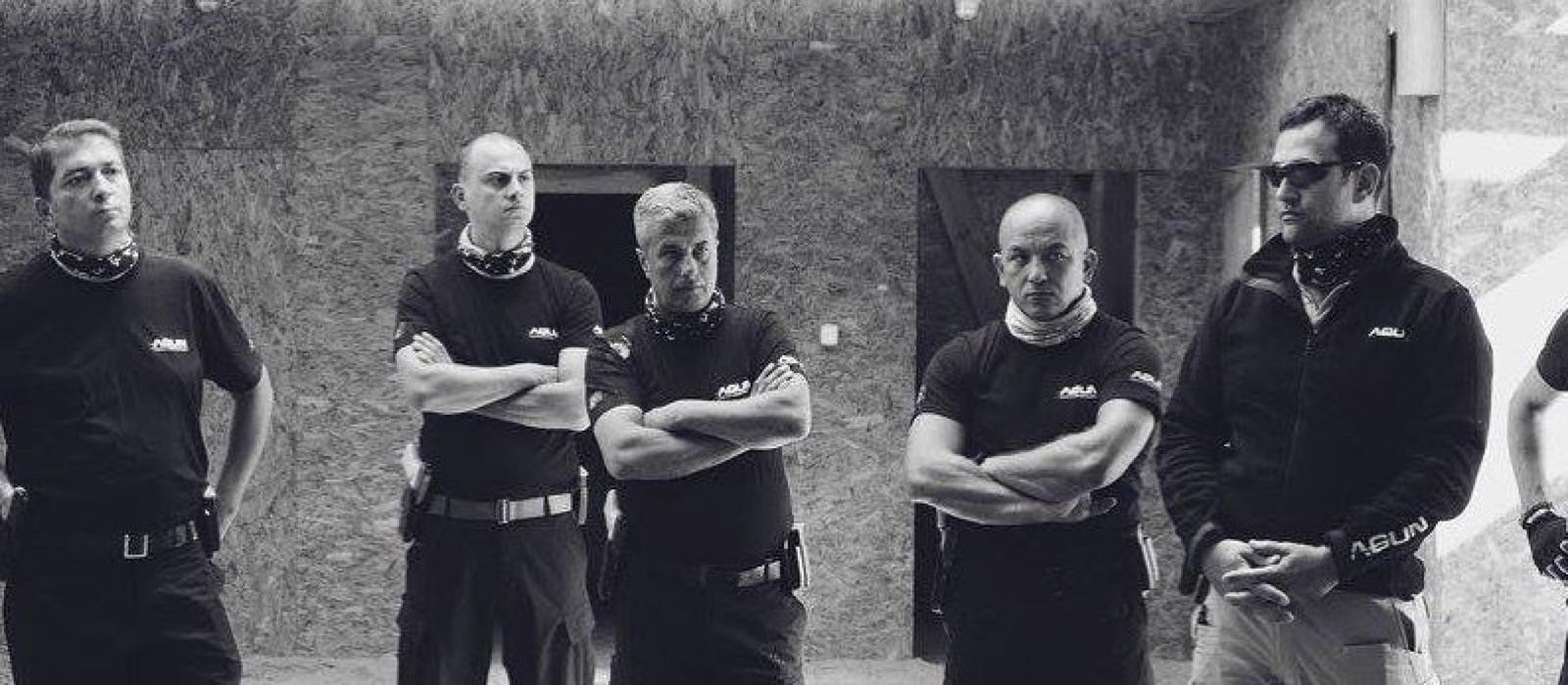 Agun Security team in black Agun uniforms, arms crossed, at a training ground